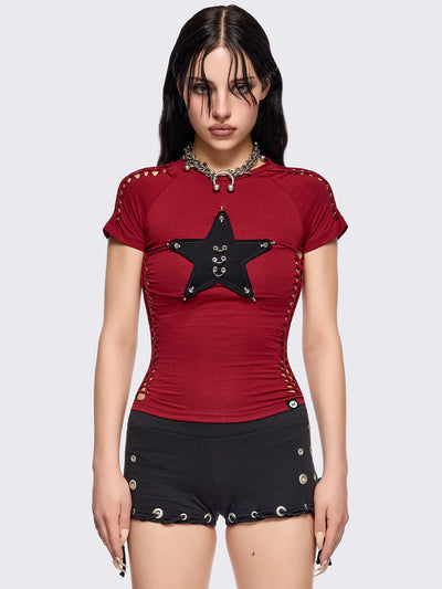 Red slitweave baby tee featuring a black front star patch with piercings.