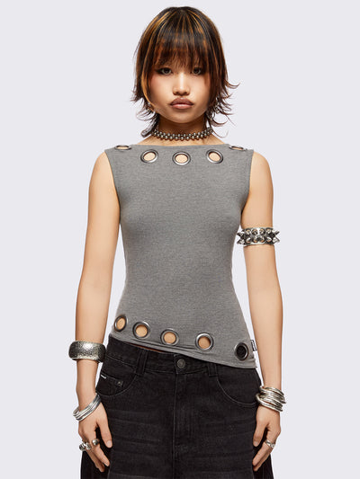 Grey asymmetric top featuring chunky eyelets along neckline and hem and boat neckline.