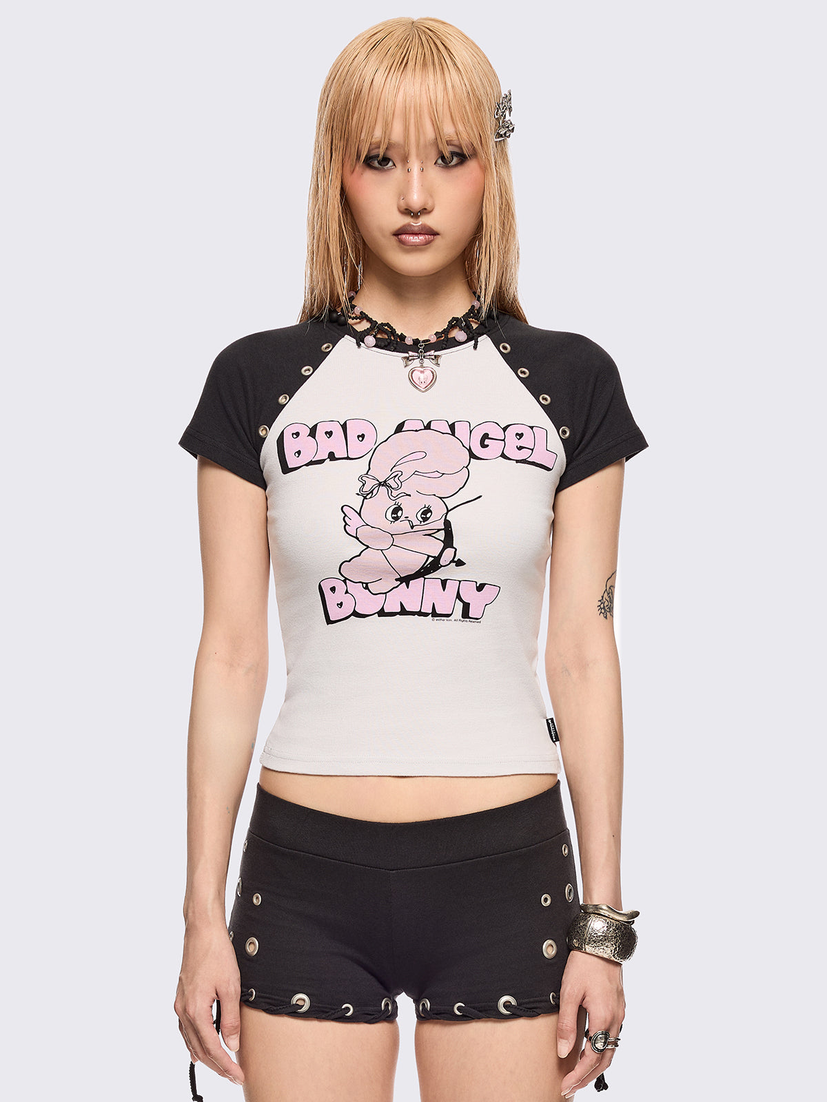 Black and white baseball tee with contrast raglan sleeves, "Bad Angel Bunny" graphic front print by Esther Bunny artist and eyelet details.