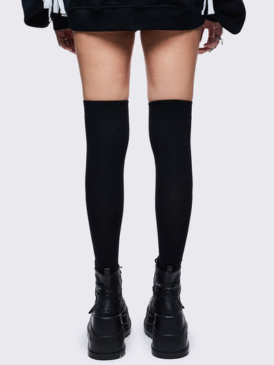 Black opaque thigh highs socks with white gun graphic design 