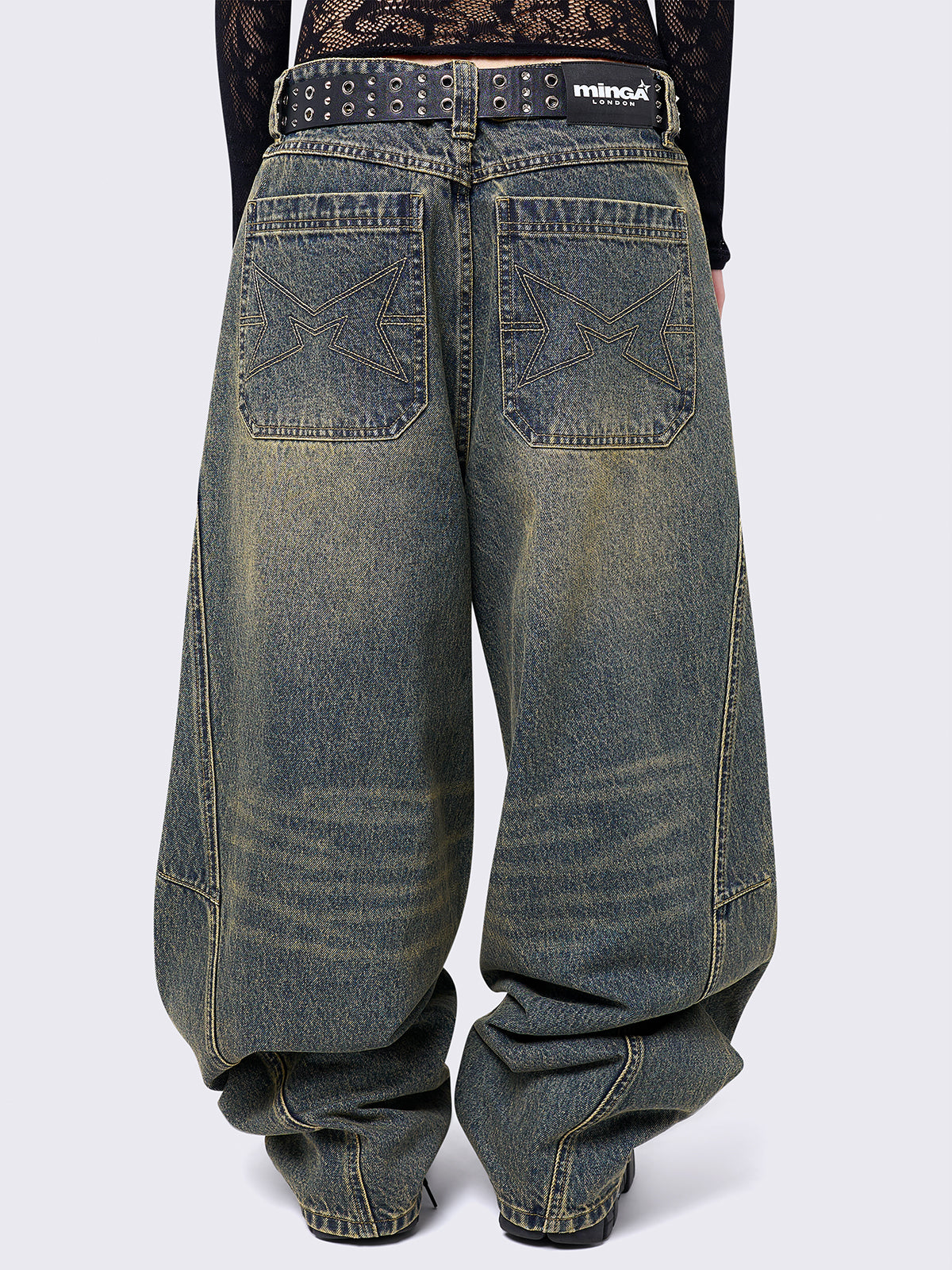 Blue washed super baggy jeans with green overdye, a relaxed fit, regular waist, zip fly, button fastening, and belt loops. Trendy streetwear style.