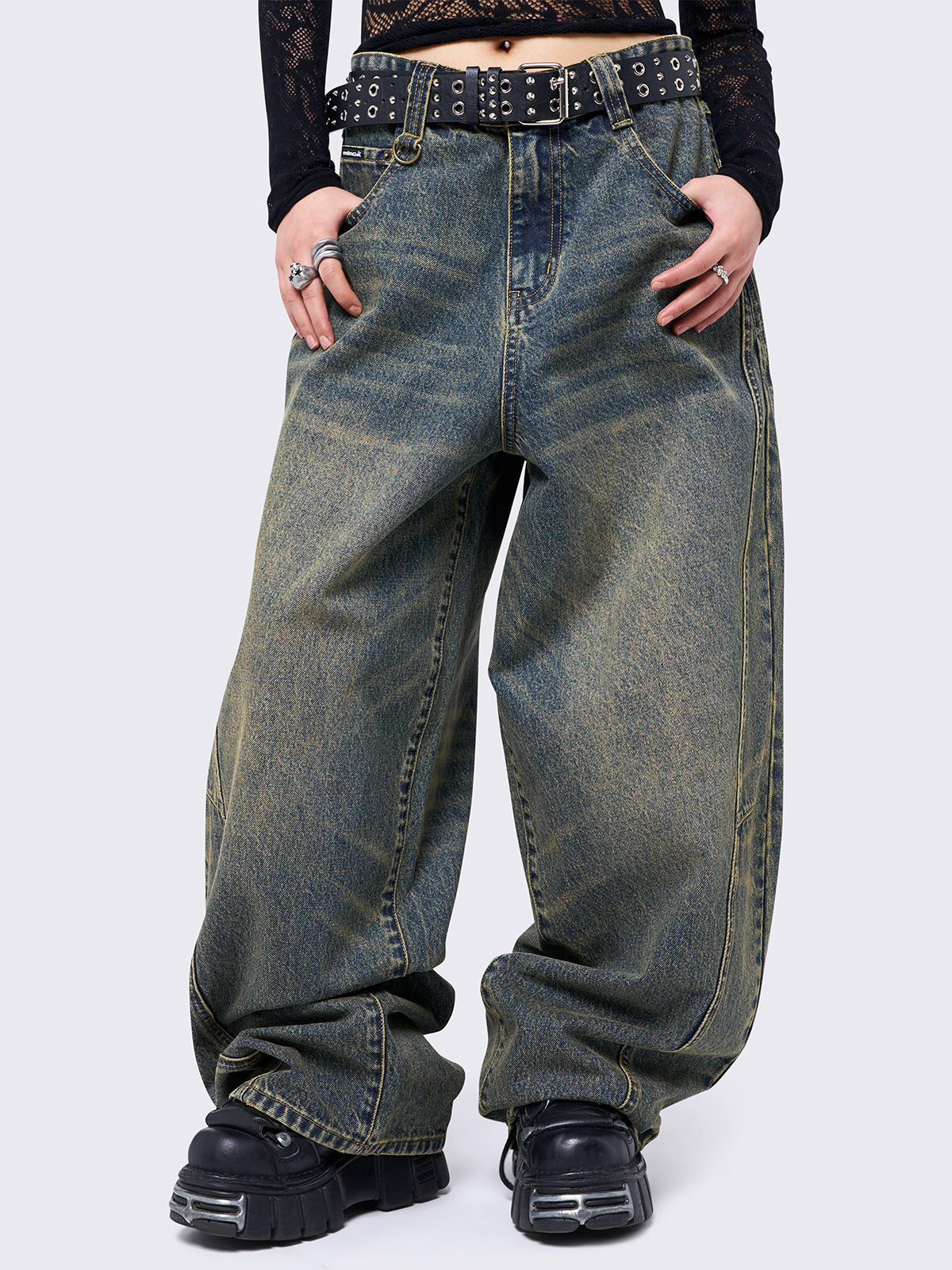 Blue washed super baggy jeans with green overdye, a relaxed fit, regular waist, zip fly, button fastening, and belt loops. Trendy streetwear style.