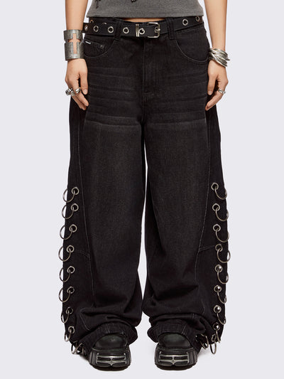 Black washed super baggy jeans with silver chunky eyelets along sides with O-rings. Oversized fit.