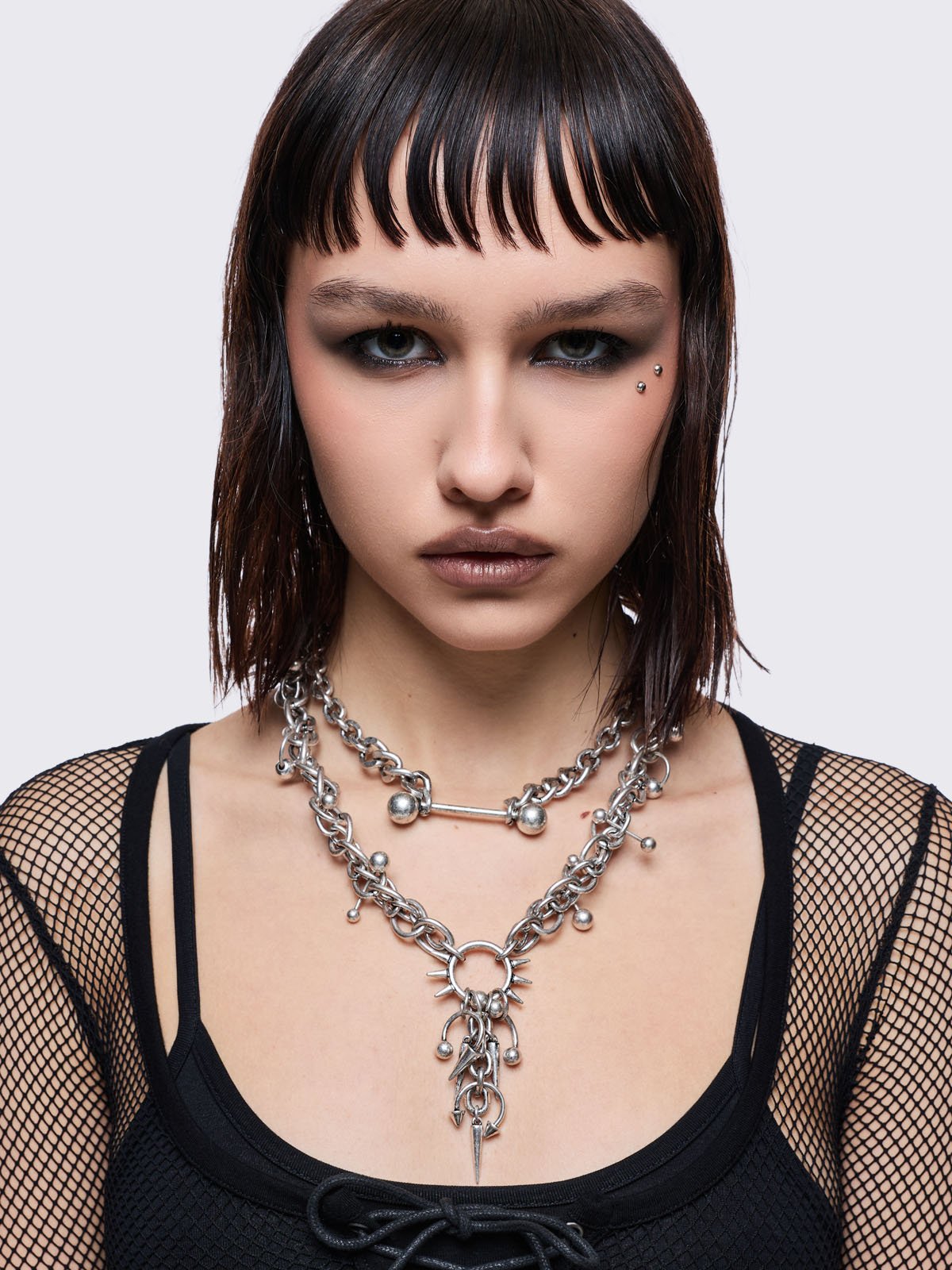 Set of 2 silver necklaces with spike and piercing details 