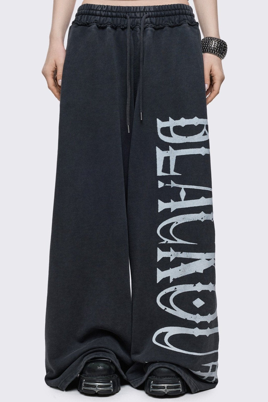 Grey washed sweatpants with "blackout" graphic side print in white.