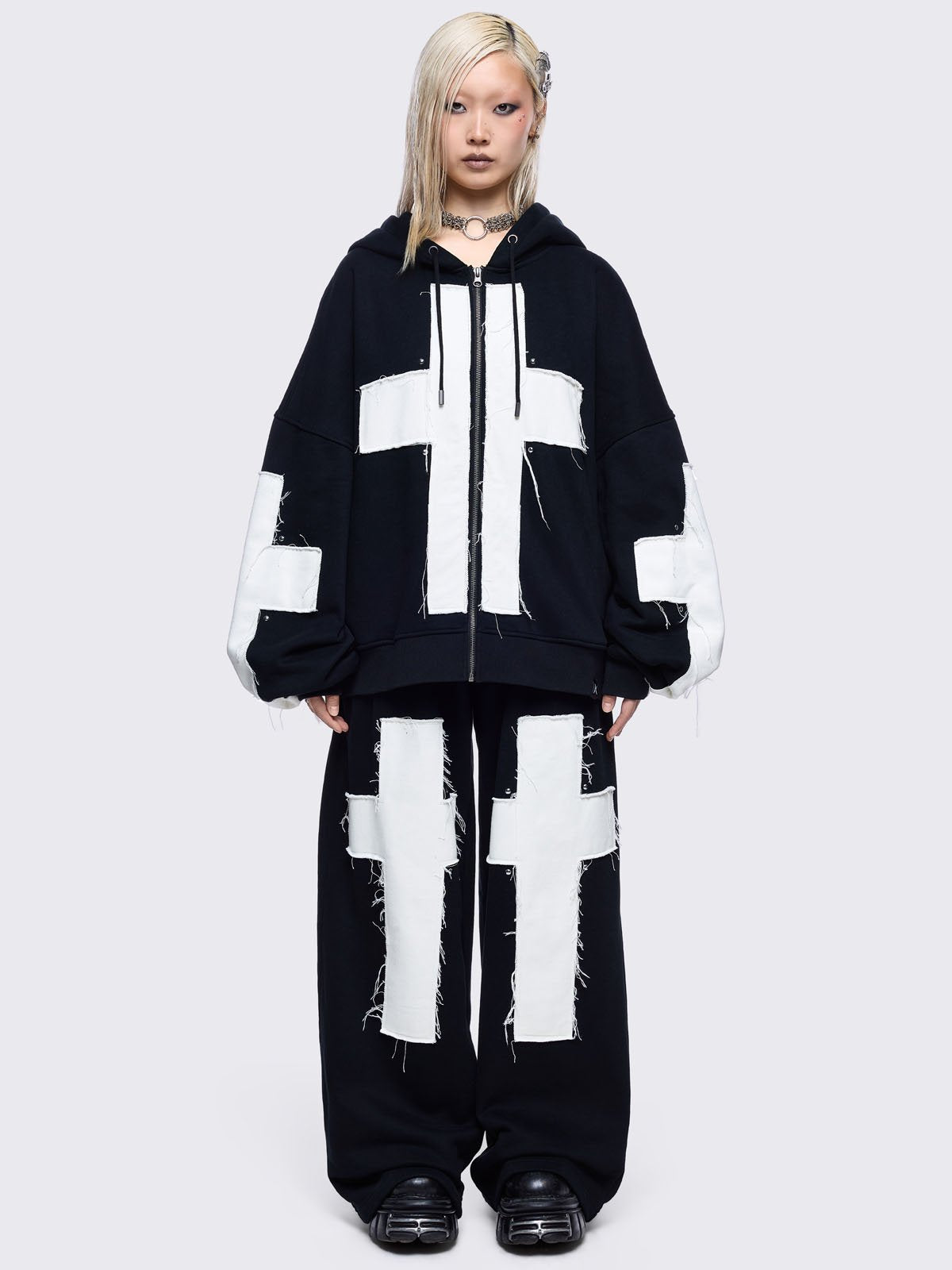 Black sweatpants with white chunky cross patches