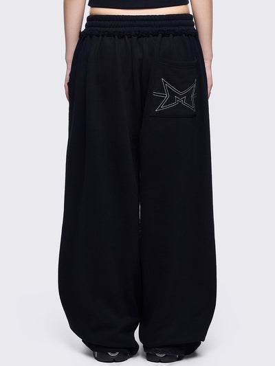 Black sweatpants with white chunky cross patches
