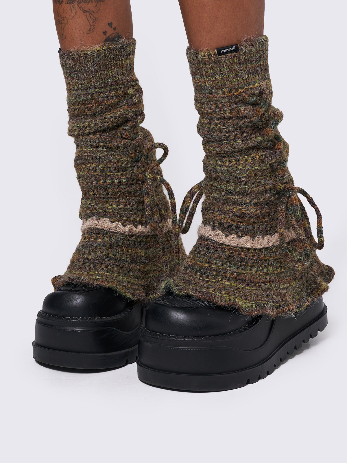 Boho crochet flared leg warmers featuring a space-dye design, lace up and ruffles details.