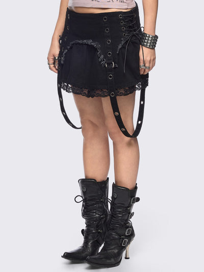 Black denim mini skirt with distressed frayed panels, lace up side details and eyelet straps.
