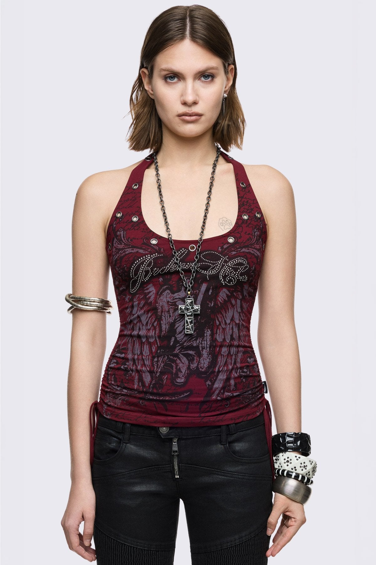 Red cotton halter tank top with Broken Halo graphic, rhinestones, and eyelets, ruched sides in grunge Y2K style.