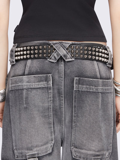 Black vegan leather belt featuring spike studs and square buckle fastening with double keeper.
