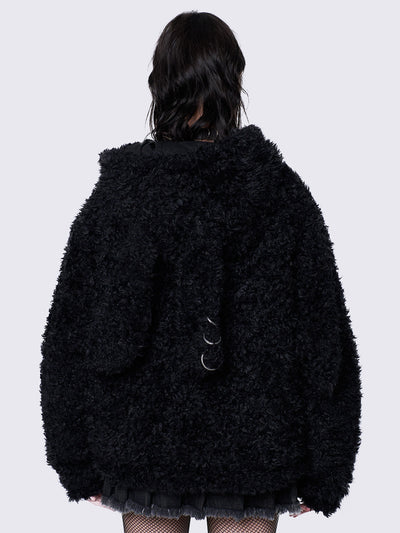 Black fuzzy zip-up jacket with bunny ear hood, oversized fit, and soft faux fur texture. 