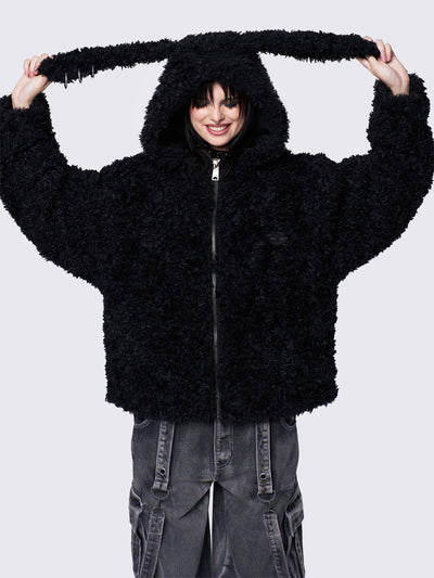 Black fuzzy zip-up jacket with bunny ear hood, oversized fit, and soft faux fur texture. 