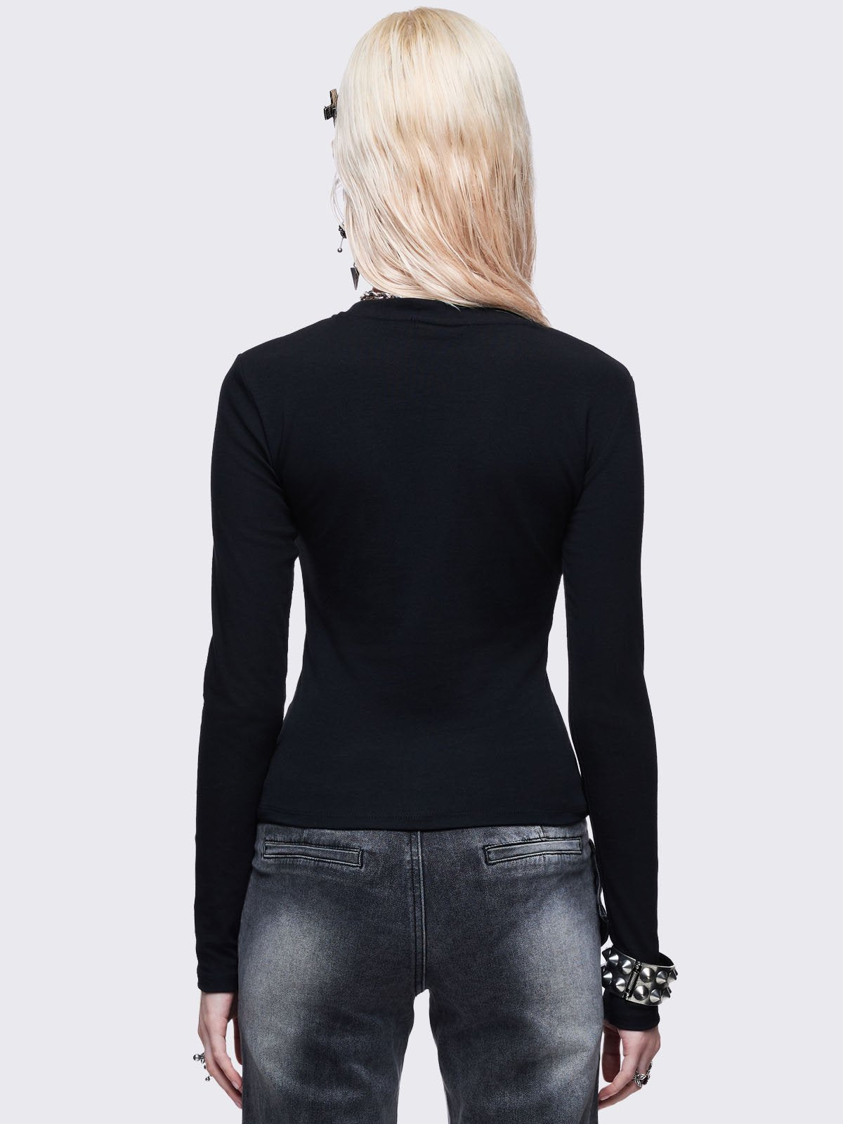 Black long sleeve top with sigilism heart rhinestone design.