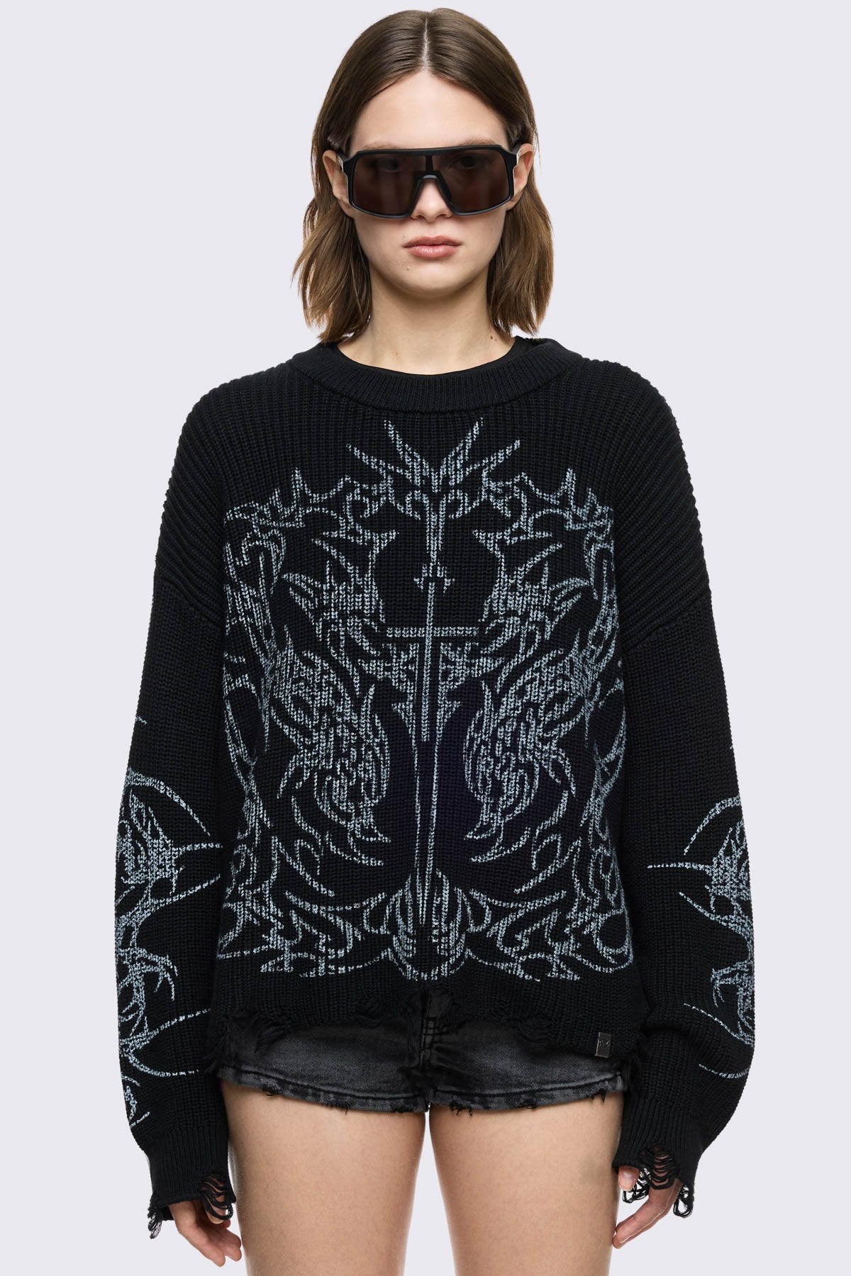 Black knitted jumper with cross sigilism graphic design and distressed rib 