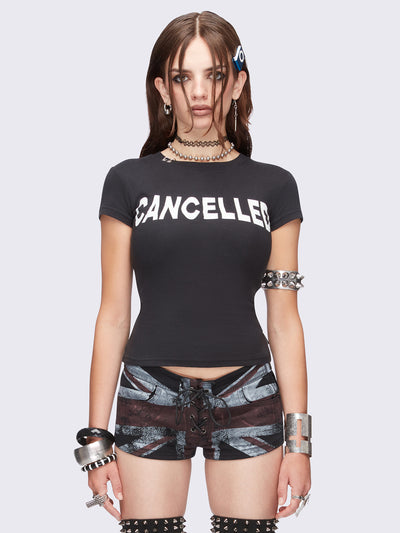 Black graphic baby tee with "Cancelled" print and piercing O-ring details.