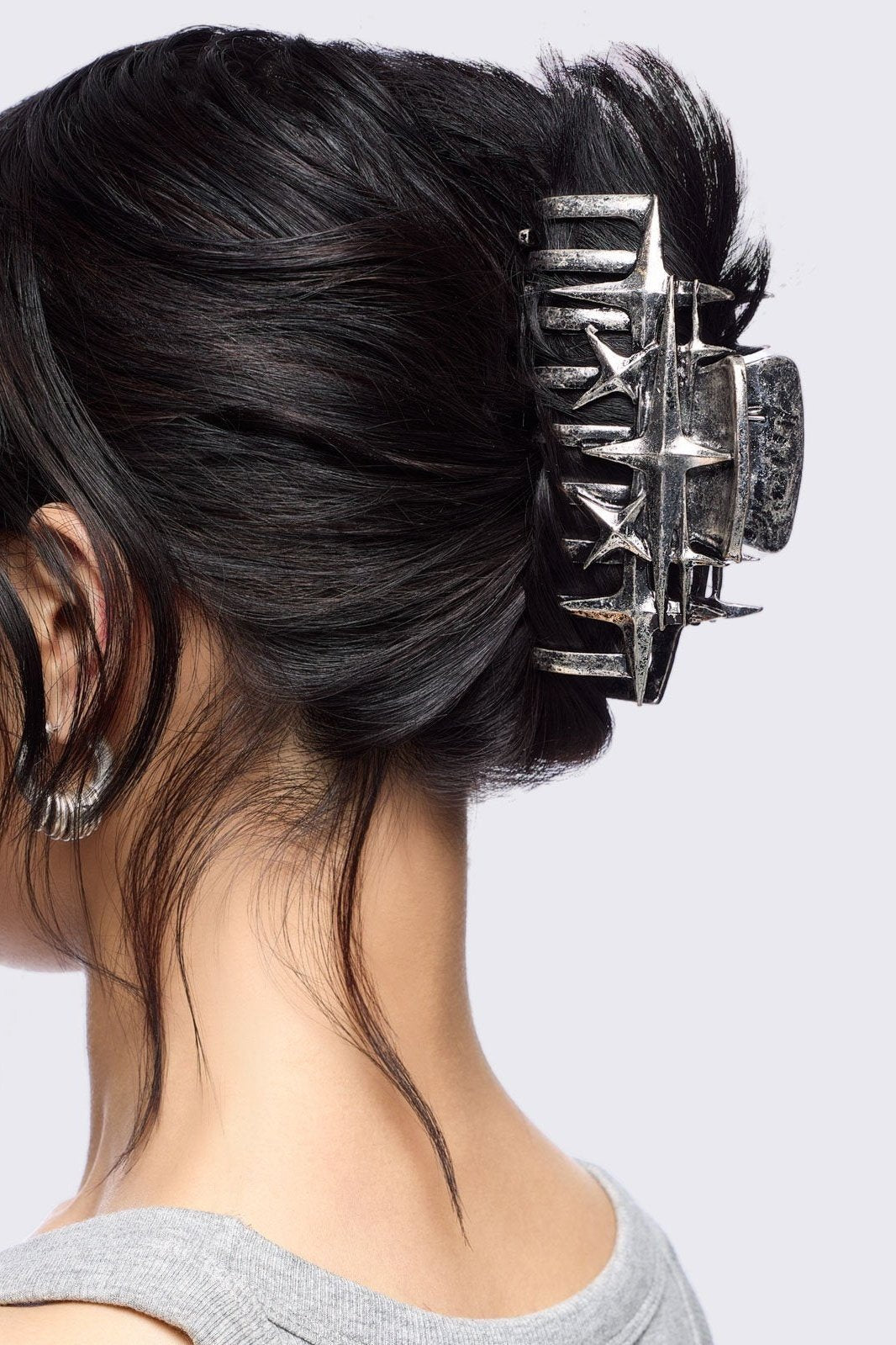 Metal hair claw clip with stars design.