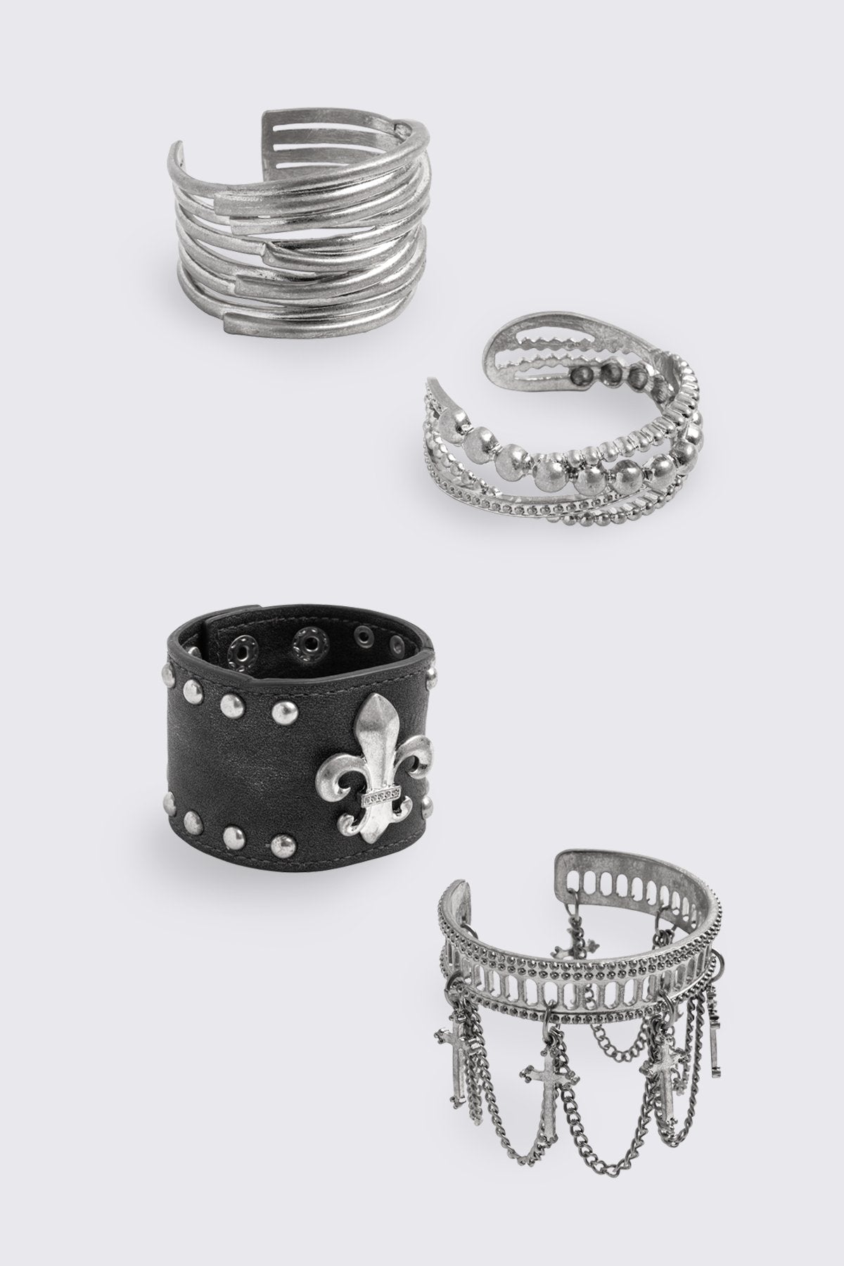 Black PU and antique-silver bracelet set with cross, fleur-de-lis and chain details in a grunge goth style.