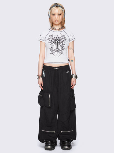 Off-white graphic raglan baby tee with tribal cross print and black contrast stitching.
