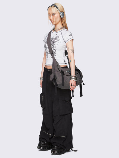 Off-white graphic raglan baby tee with tribal cross print and black contrast stitching.