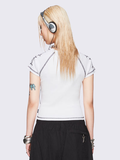 Off-white graphic raglan baby tee with tribal cross print and black contrast stitching.