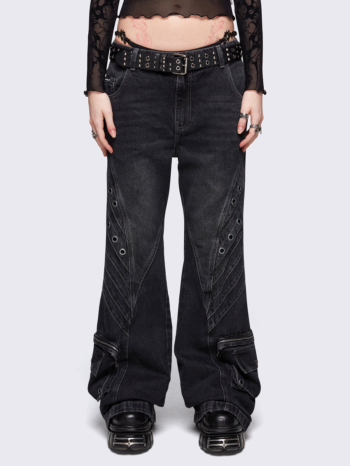 Black washed flare baggy jeans with grey overdye, twist seams, eyelet details and utility ankle pockets.