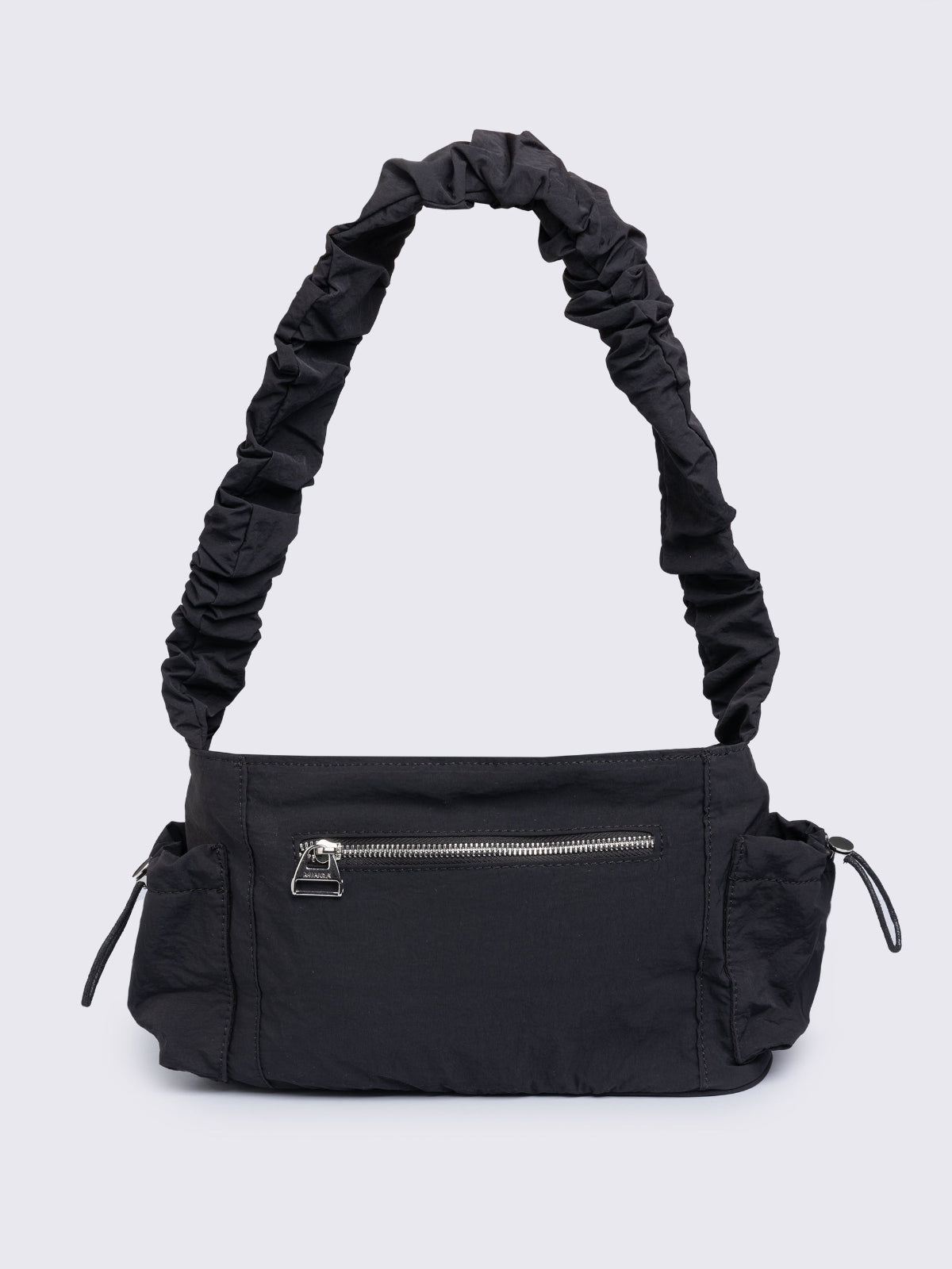 Black shoulder bag with ruched strap, lace-up ribbon front pockets, detachable plush pink bunny charm, and multiple pockets.