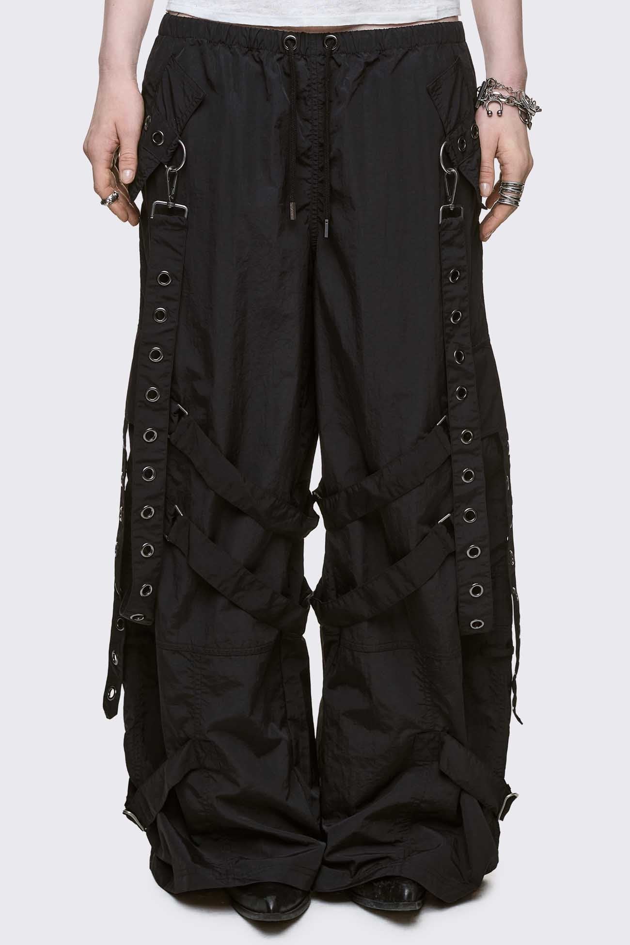 Black tech parachute cargo pants with all over straps, hardware details and utility pockets. 