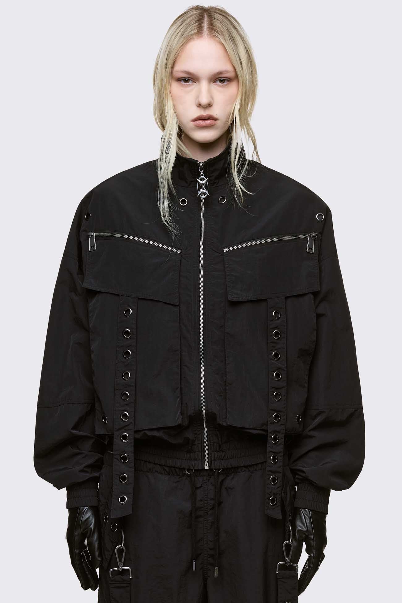 Black boxy oversized windbreaker jacket with straps and metal hardware details. 