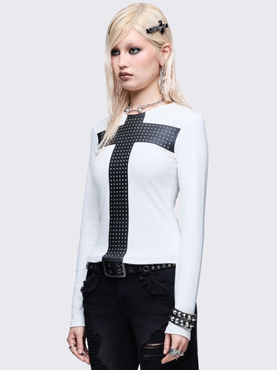 White long sleeve top with black chunky cross with silver studs