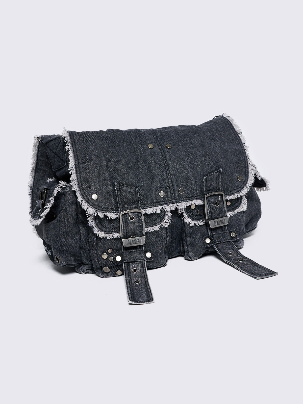 Black wash denim shoulder bag with frayed edges, flap closure, buckle straps, and studded details. Perfect for grunge and Y2K-inspired streetwear.