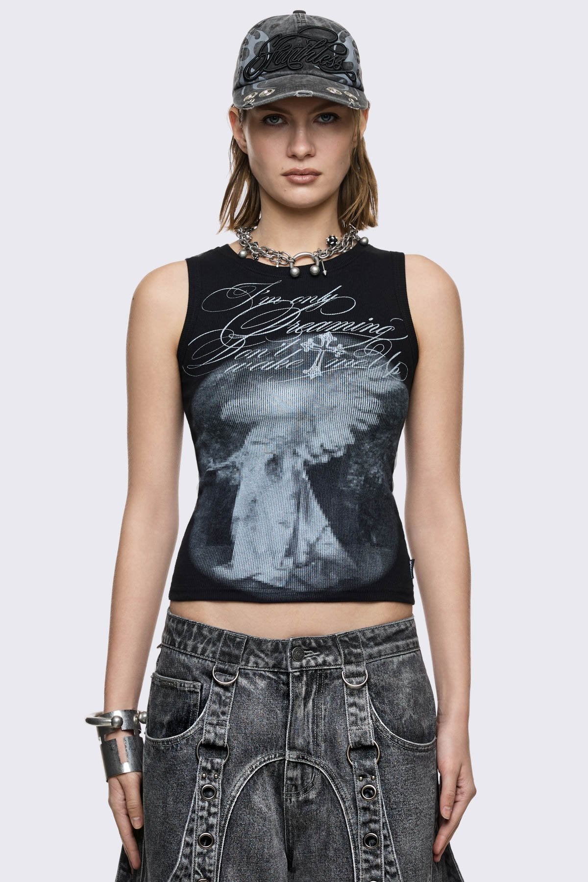 Black ribbed cotton tank top with angel graphic and script print, slim fit in a grunge Y2K style.