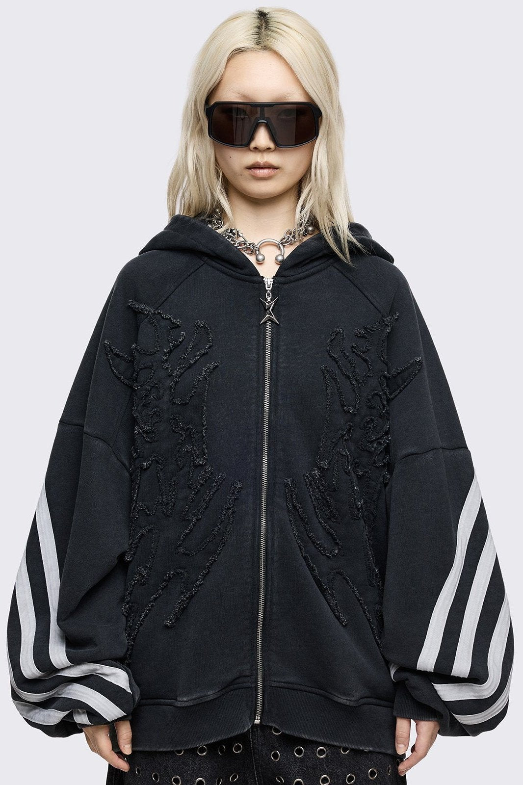 Black oversized zip up hoodie with white stripes and raw patch.