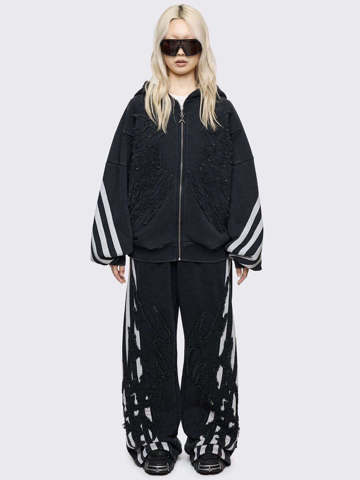 Black oversized zip up hoodie with white stripes and raw patch.