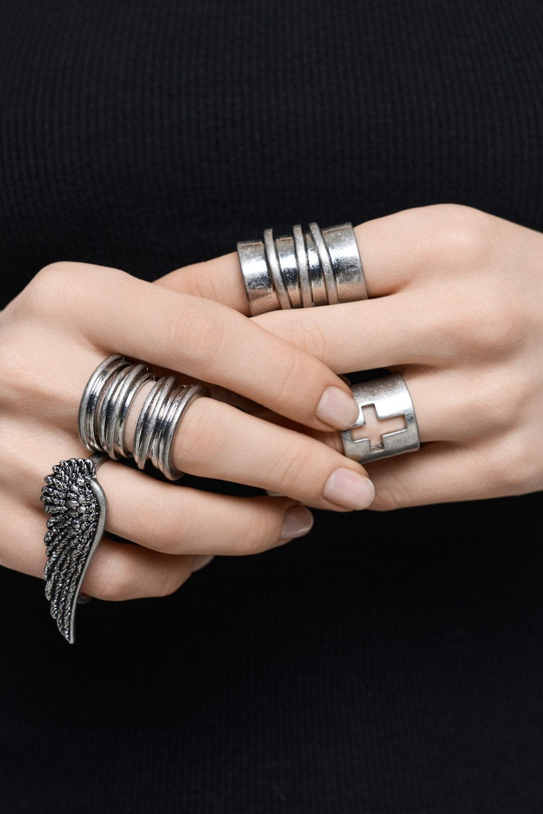 Set of 4 silver rings with wing and cross designs