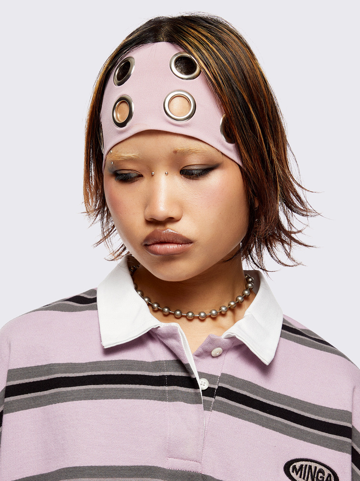 Headband in baby pink with chunky silver eyelets. 