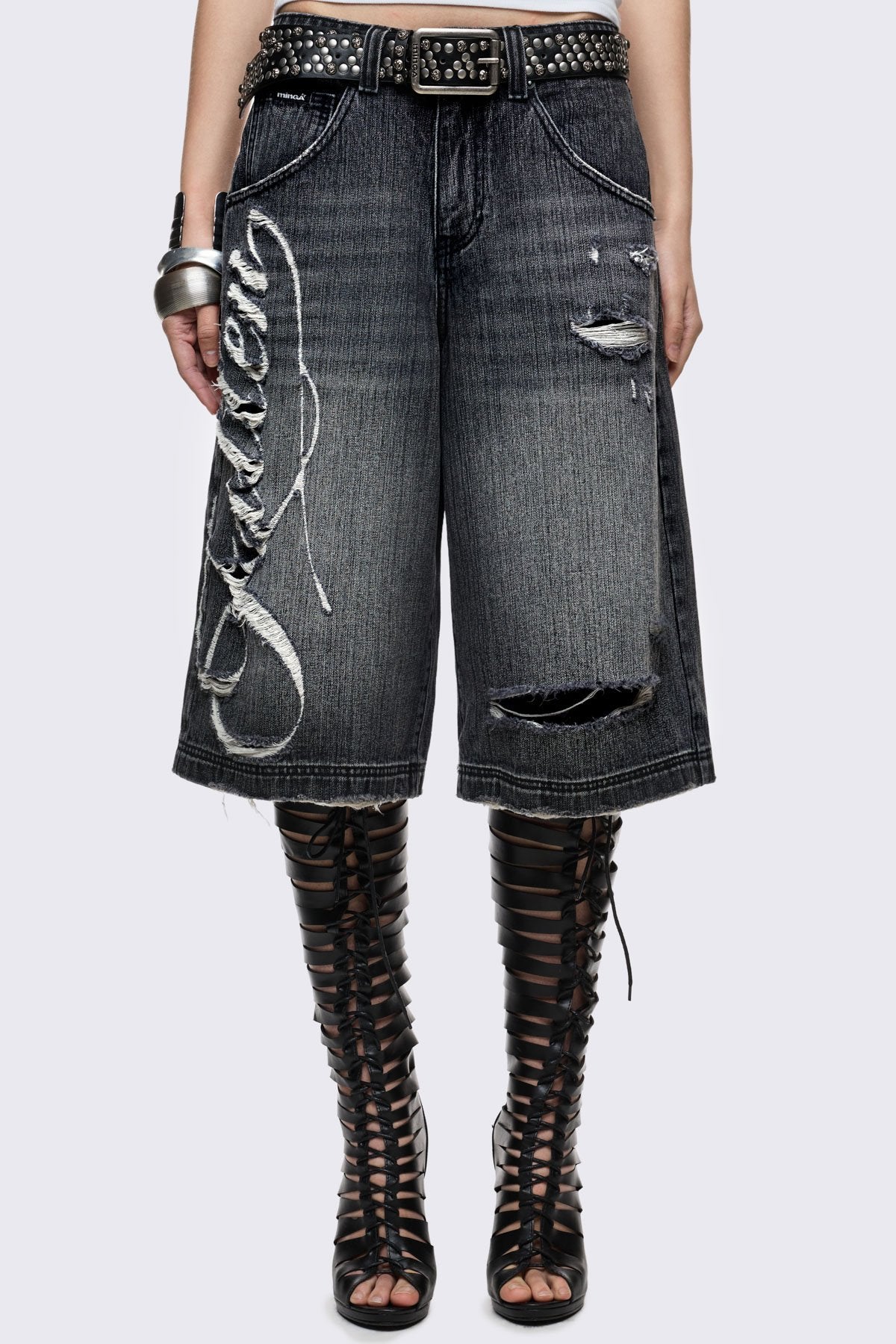 Black washed denim jorts with "Fallen" embroidery, ripped details and a relaxed longline fit in grunge Y2K style.