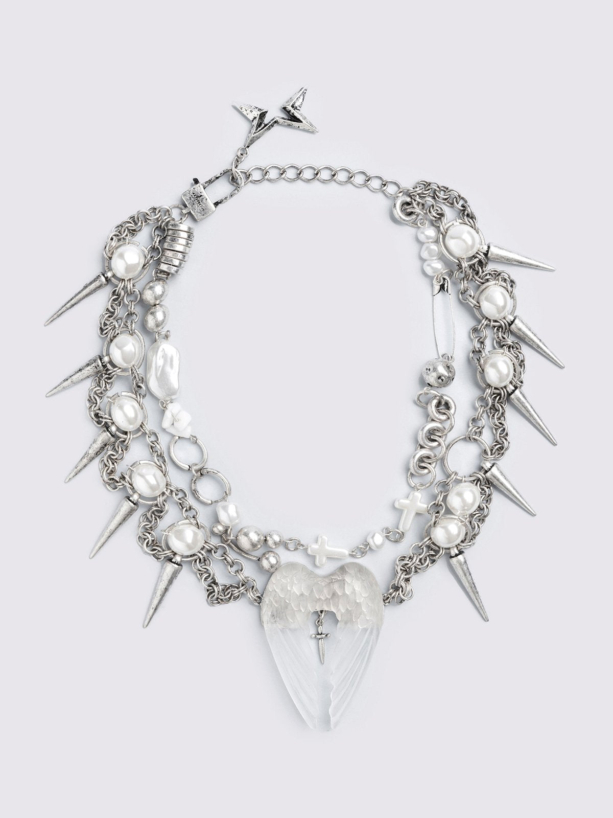 Chunky silver charm necklace with spike, pearl, piercing and cross details and a chunky angel wings pendant.