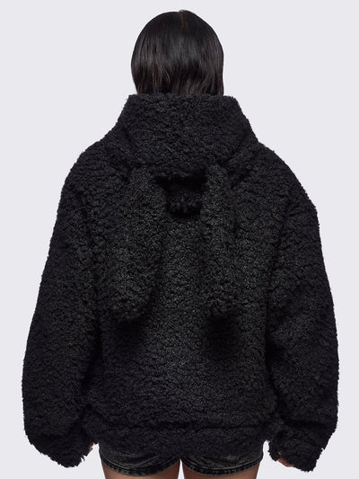 Black faux fur coat featuring a bunny ear hood and faux leather details with silver studs.