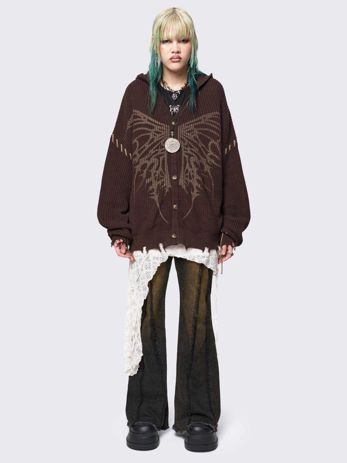 Brown chunky knit hooded cardigan featuring a dark beige butterfly graphic on the front. Includes contrast lace-up details and distressed trims for a fairy core stylish, edgy look.