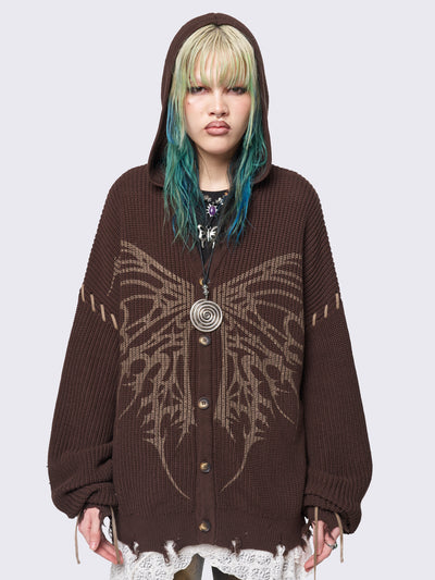 Brown chunky knit hooded cardigan featuring a dark beige butterfly graphic on the front. Includes contrast lace-up details and distressed trims for a fairy core stylish, edgy look.