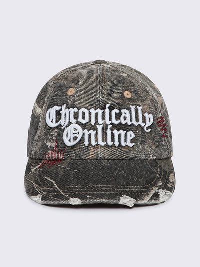 Forest tree como print denim baseball cap with "Chronically online" chunky embroidery and distressed details.