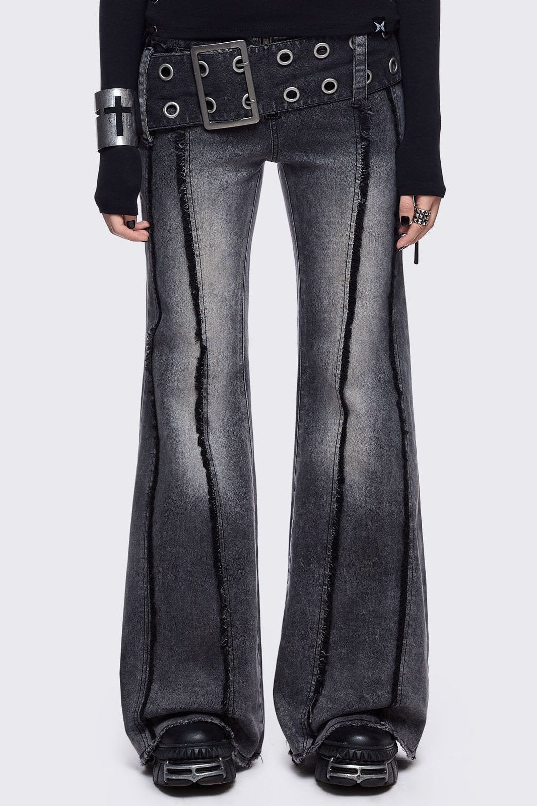Grey flared jeans with light grey overdye featuring a chunky buckle belt and distressed seams details.