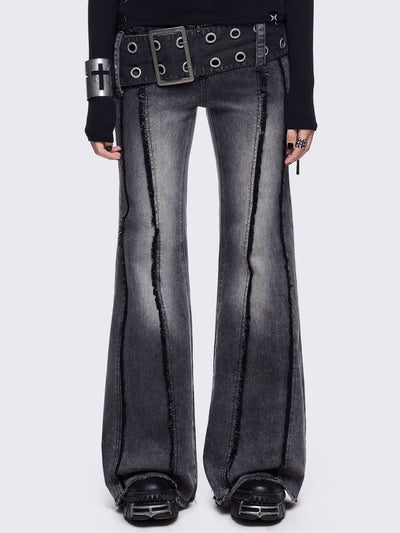 Grey flared jeans with light grey overdye featuring a chunky buckle belt and distressed seams details.