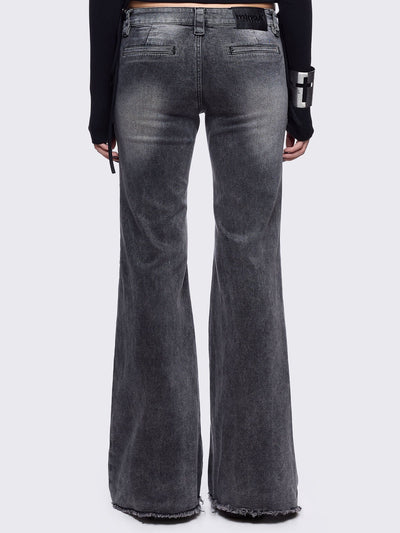 Grey flared jeans with light grey overdye featuring a chunky buckle belt and distressed seams details.
