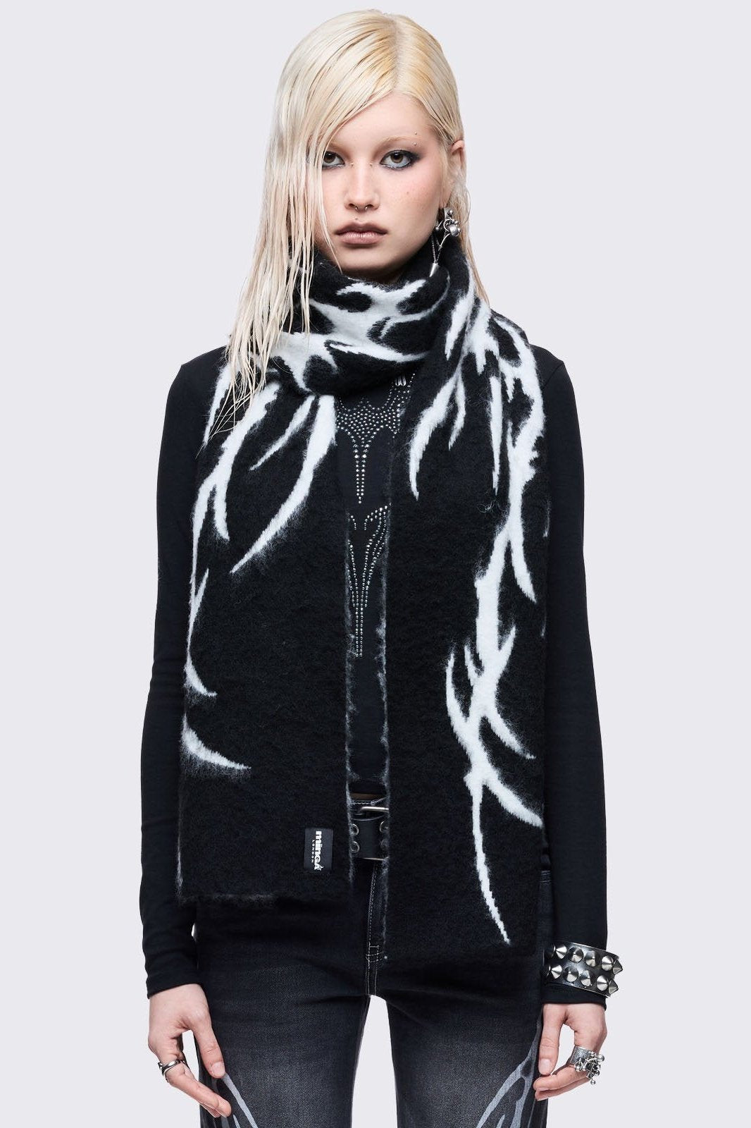 ong, chunky, and fluffy scarf featuring a high-contrast diffused tribal sigil pattern in black and grey