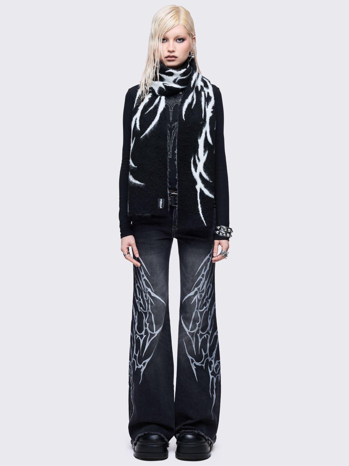 ong, chunky, and fluffy scarf featuring a high-contrast diffused tribal sigil pattern in black and grey