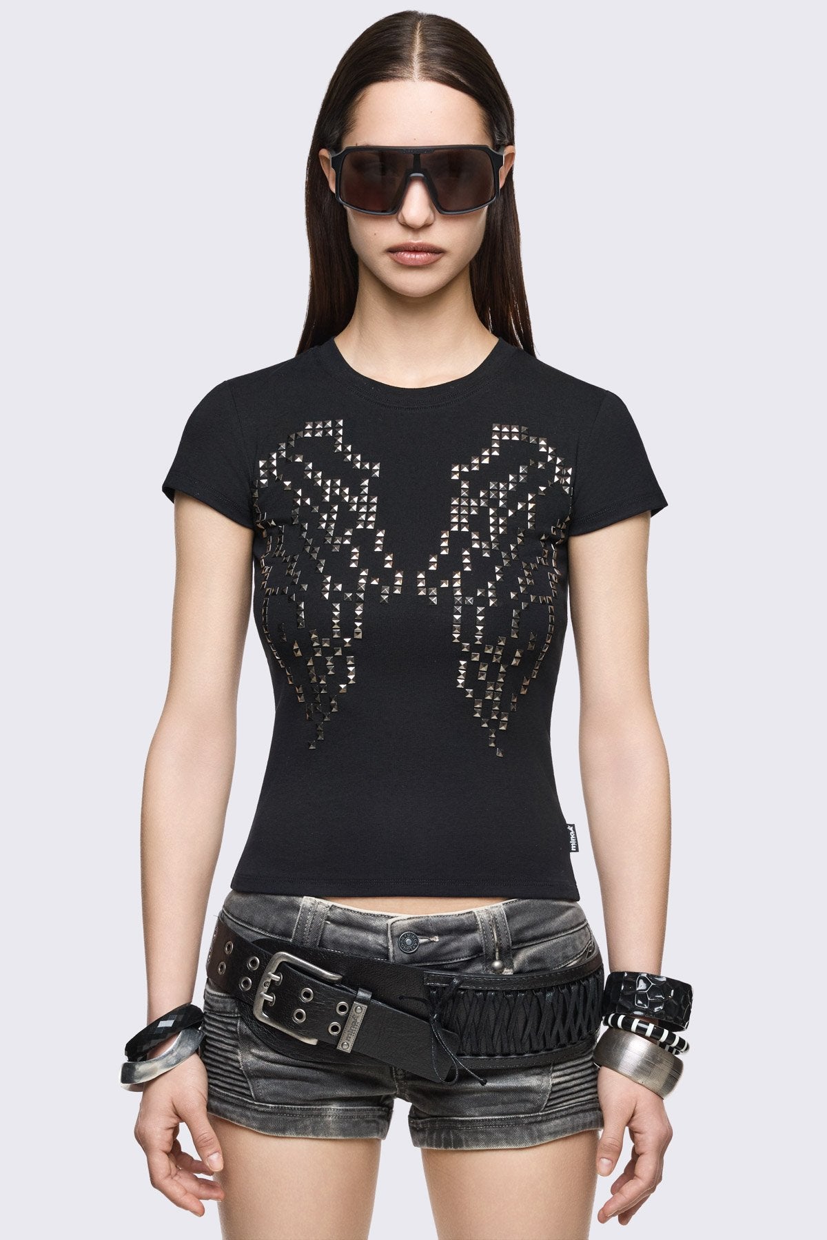 Black cotton baby tee with studded wings graphic, short sleeves and crew neck in a grunge Y2K style.