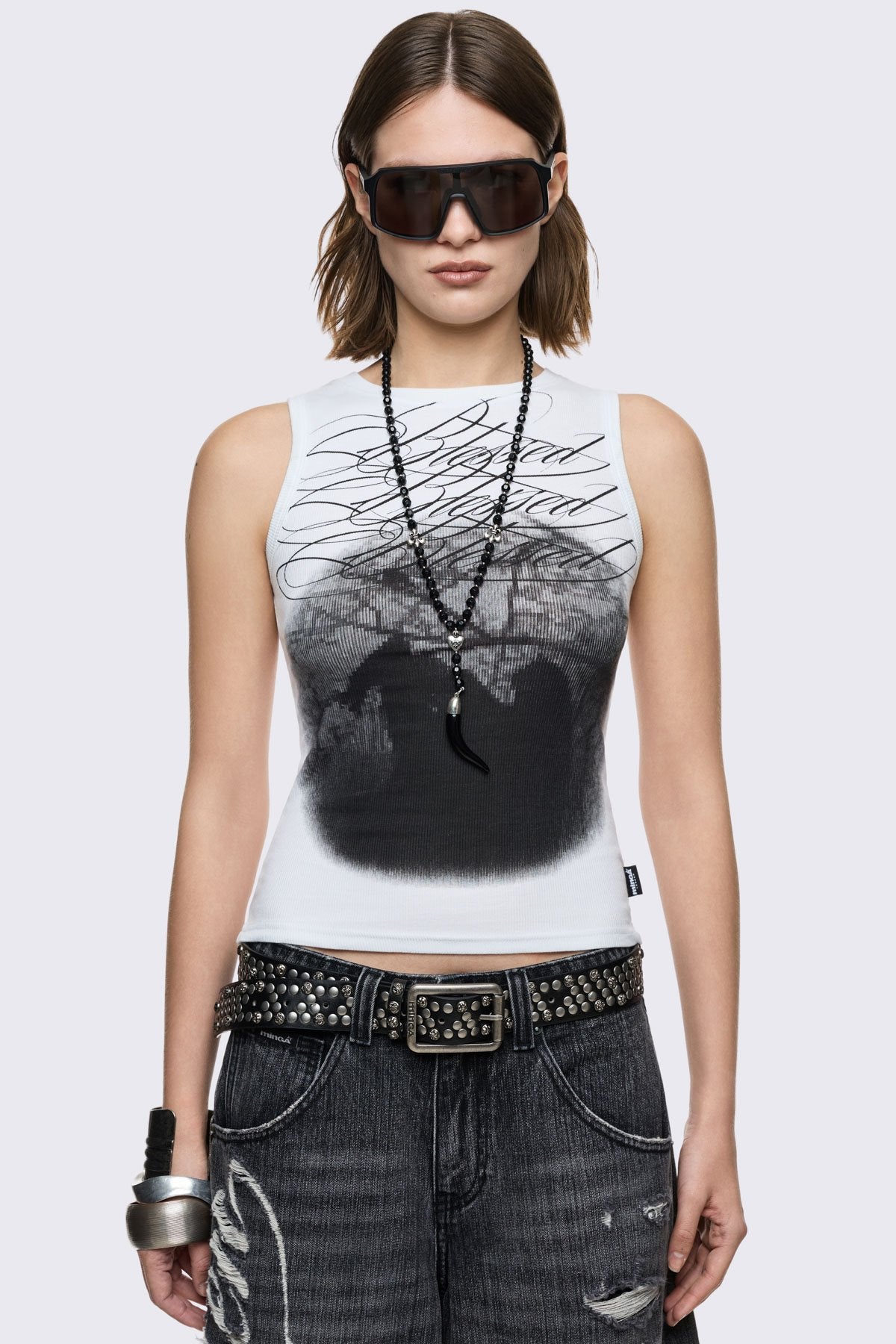 Off-white ribbed tank top with dark Blessed front print, slim fit, and grunge aesthetic.