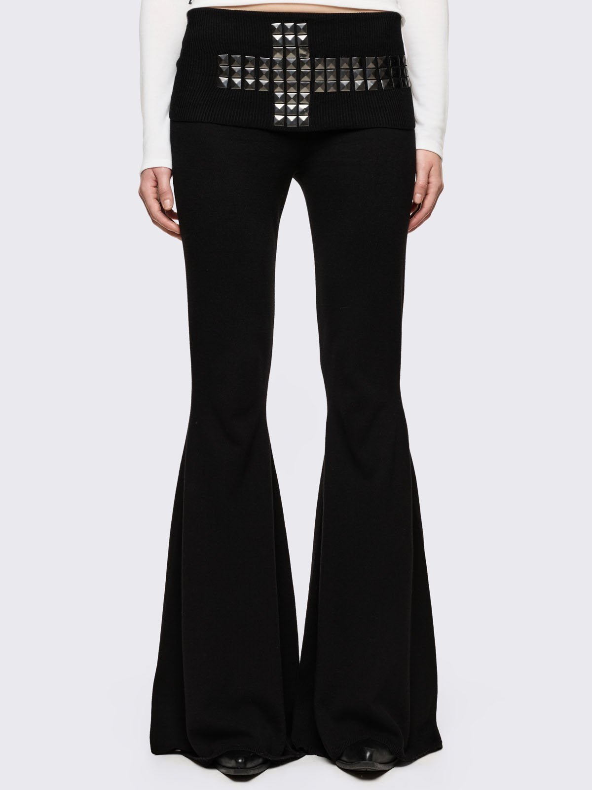 Black flare pants with folded ribbed waistband with studded cross